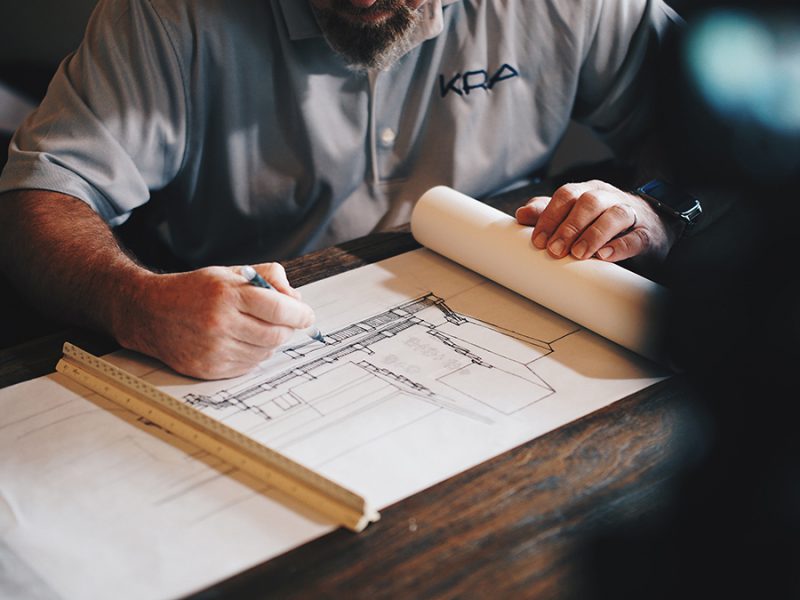 Architect reviewing blueprint drawing for new commerical property